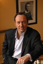 Headshot of Kevin Spacey, who is in a white dress shirt and black suit.