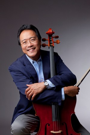 Headshot of Yo-Yo Ma, who is holding his cello and wearing a blue suit